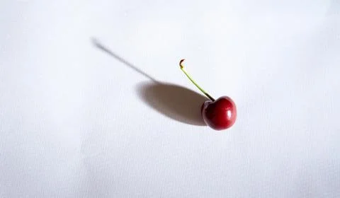 Cherry on a white background with shadows. Close-up. Top view. Stock Photos