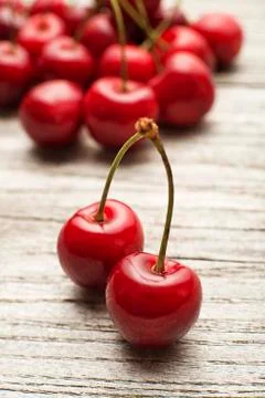 Cherry on wooden background close up. Stock Photos