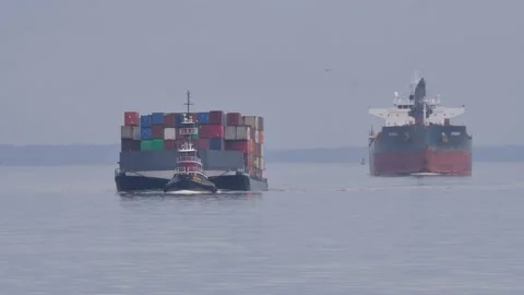 Chesapeake Bay, tugboat pulling loaded barge, tanker sailing alongside Stock Footage 197477111