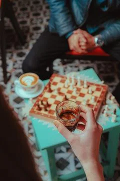Chess and coffee creating a relaxed social activity 스톡 사진