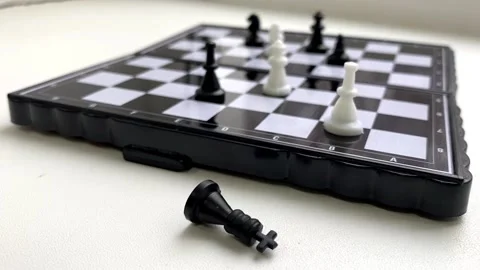 Chess. a black chess piece crawls next to the chessboard. Concept Video stock 164868396