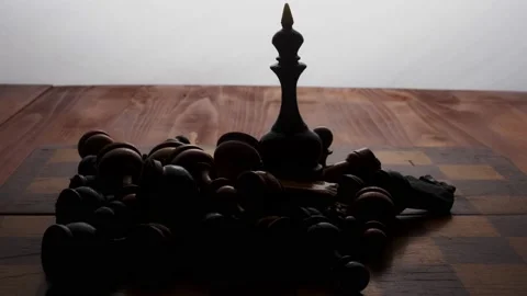 The chess Black Queen stands on a chessboard, surrounded by the rest of the lyin Stock Footage 233031342