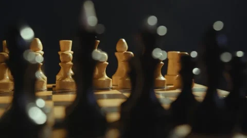 Premium Photo  Closeup of chess pieces on the chessboard under the lights  with a blurry background