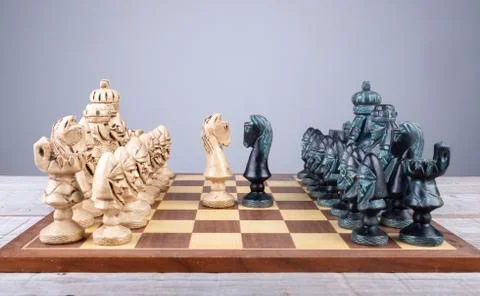 Chess board with collection pieces put in order and the horses faced Stock Photos