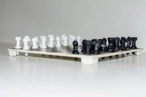 Chess board with figures on isolate white background. Stock Photos
