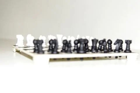 Chess board with figures on isolate white background. Stock Photos