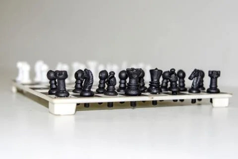 Chess board with figures on isolate white background. Stock Photos