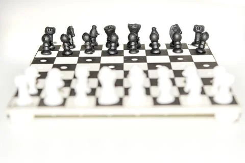 Chess board with figures on isolate white background. Фото