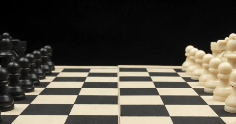 A chess board with a white and black pieces and a black background Vídeo Stock 328319874