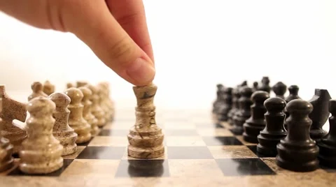 A chess board on white background, a person takes the king and puts him in front 스톡 동영상 58415501