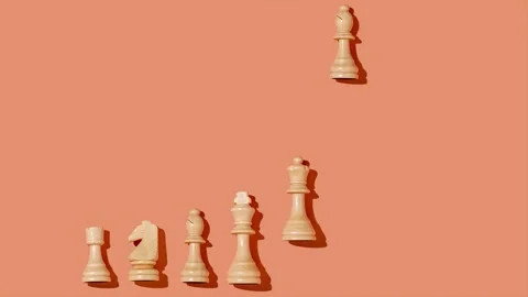 Chess on a bright orange background fall and stand in a row Stock Footage 220614142