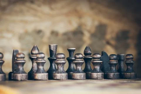 Chess casts a shadow on the wall, black pieces made of wood Stock-Fotos