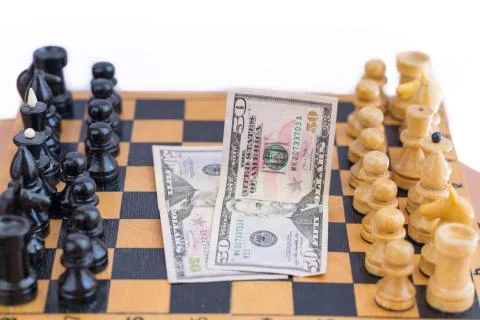 Chess components and money between them Stock Photos