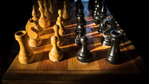 Chess is a confrontation on a dark background Stock Photos