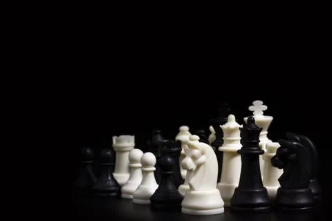 Chess in darkness on black background. Stock Photos