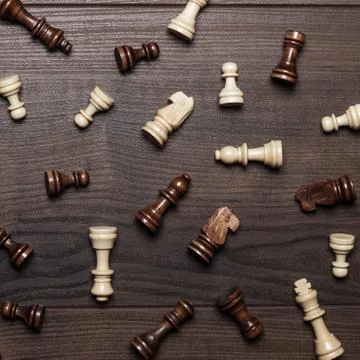 Chess figures on the brown woden table background Stock Photos