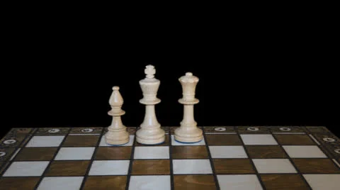 Chess figures form on chess board and prepare to battle on black background Stock Footage 23828120