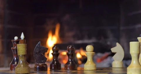 A chess game. Chess pieces on the background of the fireplace. Video stock 110692244