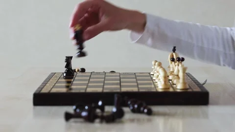 A chess game ends with the black pieces being swept off the board Stock Footage 278900738