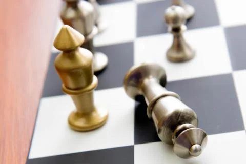 Chess game - fallen silver king on chessboard Stock Photos