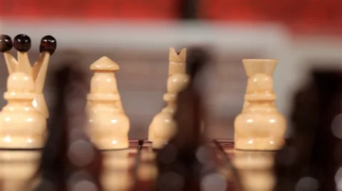 Premium Photo  Closeup of chess pieces on the chessboard under the lights  with a blurry background