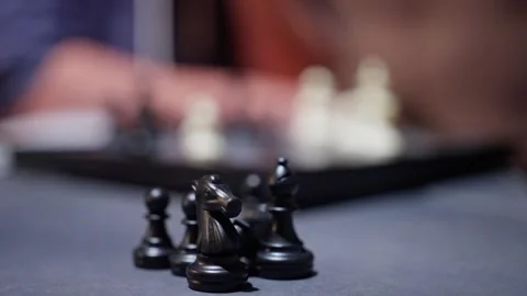 A chess game is illustrated closeup, emphasizing the intricate black pieces that Stock Footage 317102501