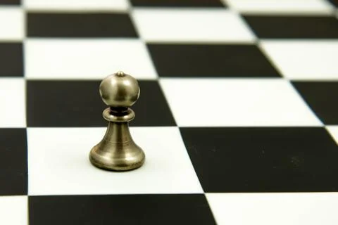 Chess game - pawn alone in front on chessboard Stock Photos