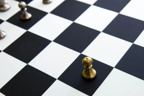 Chess game - pawn alone in front on chessboard Stock Photos