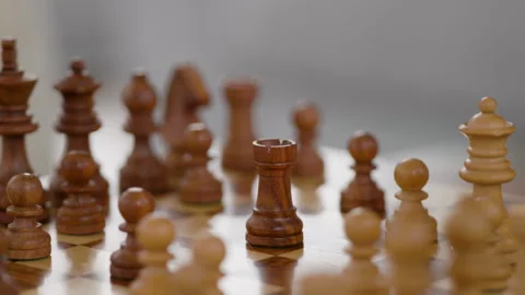 Chess game in progress with player moving a rook piece on wooden board Stock Footage 324069951