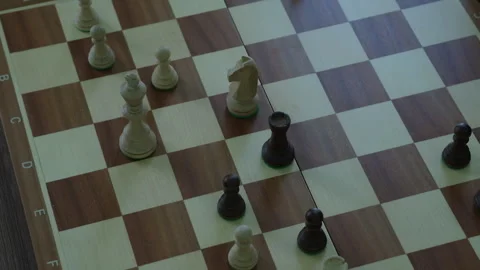 Chess game in progress with several pieces still on board Видео 294397064