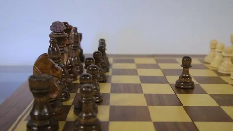Chess game start. Black pawn opens party in chess, using the right of first move Stock Footage 79109466