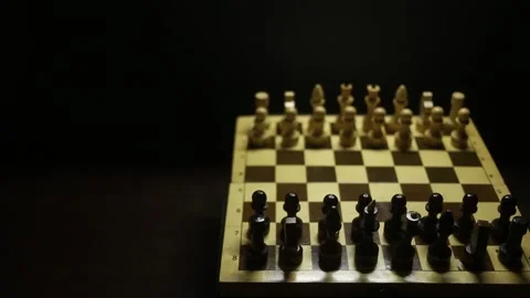 A chess game in sullen shadow with black and white game pieces in smoke. Stock Footage 167041323