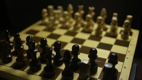 A chess game in sullen shadow with black and white game pieces in smoke. Stock Footage 167041361