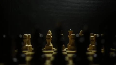 A chess game in sullen shadow with black and white game pieces in smoke. Stock Footage 167041363
