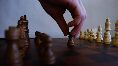 Drawing on white background of someone moving a pawn on a chess board with  impact effects