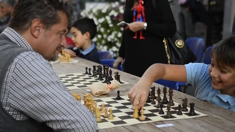 Chess match between father and son Stock Footage 88817092