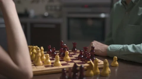 Chess match in kitchen, showcasing concentration and strategic thinking Video stock 148339555