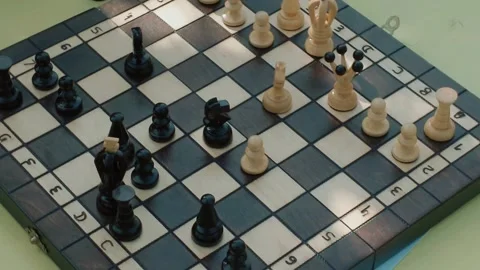Chess match in progress with wooden pieces on board Stock Footage 335998950
