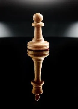 Chess pawn on a black background with the reflection of the chess queen. Care Stock Photos