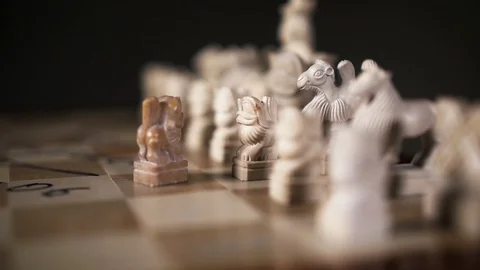 Chess pawn form lion close up move player to opponent on chessboard slowmotion. Stock Footage 119347079