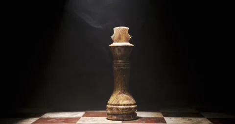Chess piece on a checkered board with dramatic lighting Stock Footage 340482609
