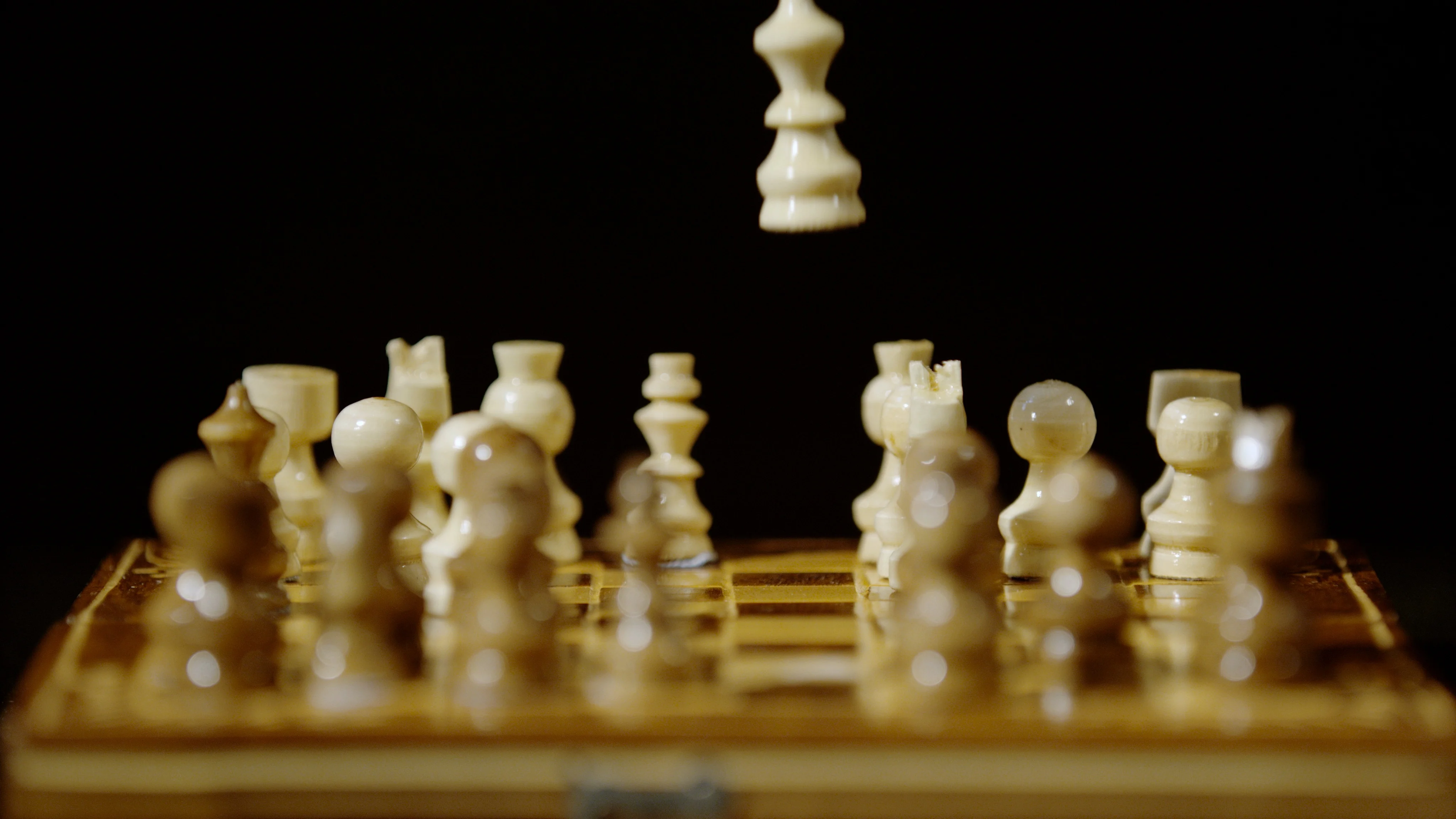 Super Slow Motion Chess Pieces Fall on the Chessboard. Filmed on a