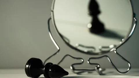 A chess piece is reflected in the mirror. Things are not what they seem. Video stock 143632282