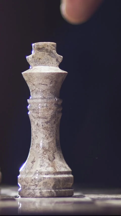Chess piece in slow motion as a hand moves the king in a game Stock Footage 338141084