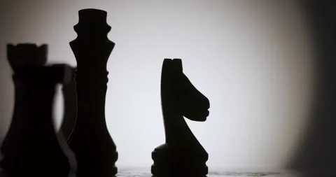 Chess pieces are arranged on a table with a plain background Stock Footage 339303587