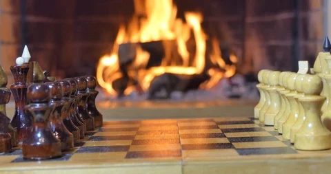 Chess pieces on the background of the fireplace. Video stock 110692124