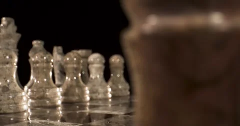 Chess pieces on the board in a close-up view with dark background Stock Footage 339303579
