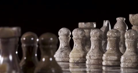Chess pieces on a board ready for a game in low light Stock Footage 339303574