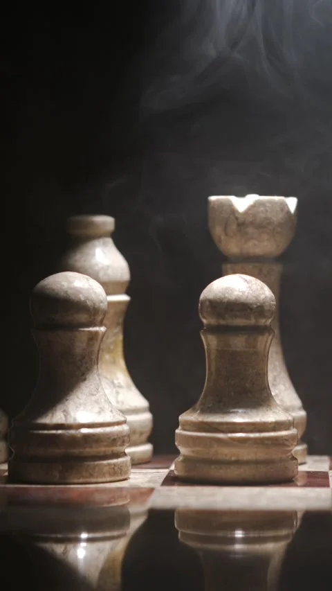 Chess pieces on a board with smoke effects during a game session Stock Footage 339303554