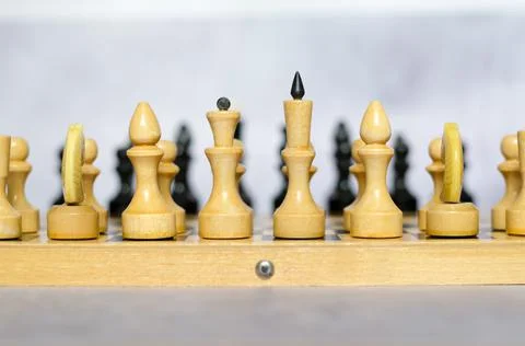 Chess pieces on a chessboard side view, selective focus. White pieces Stock Photos
